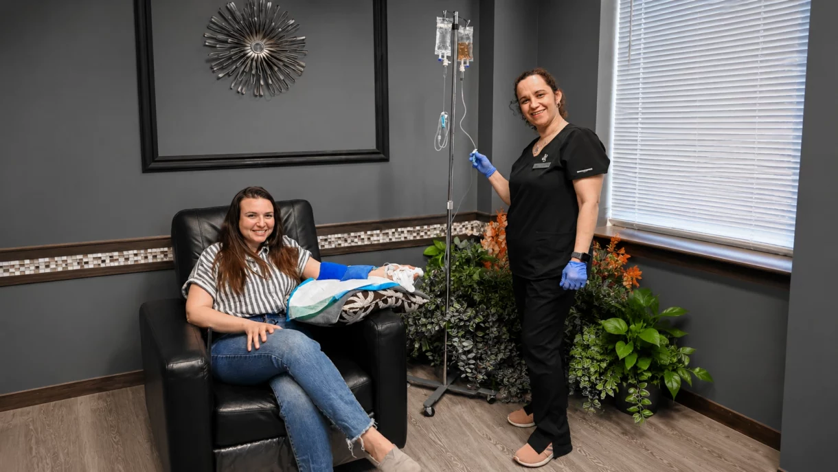 Patient receiving IV vitamin therapy during an executive physical exam at Next Health Med clinic, with a medical professional providing personalized care